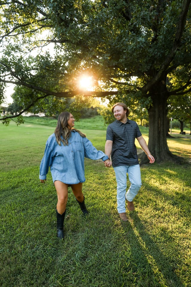 Couple walking through a golden hour field