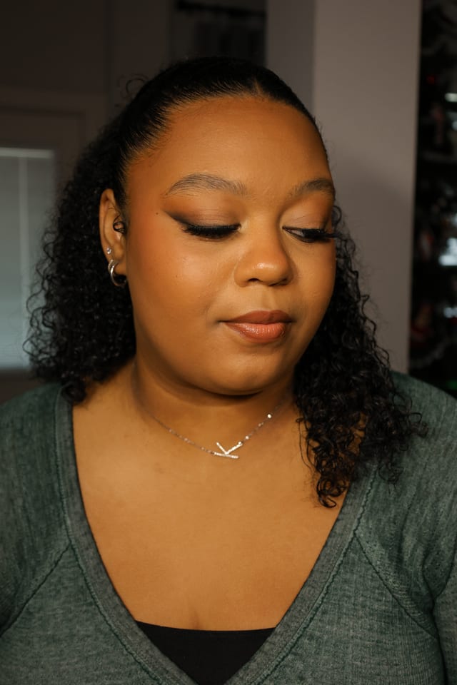 Sleek pulled-back style with soft glam