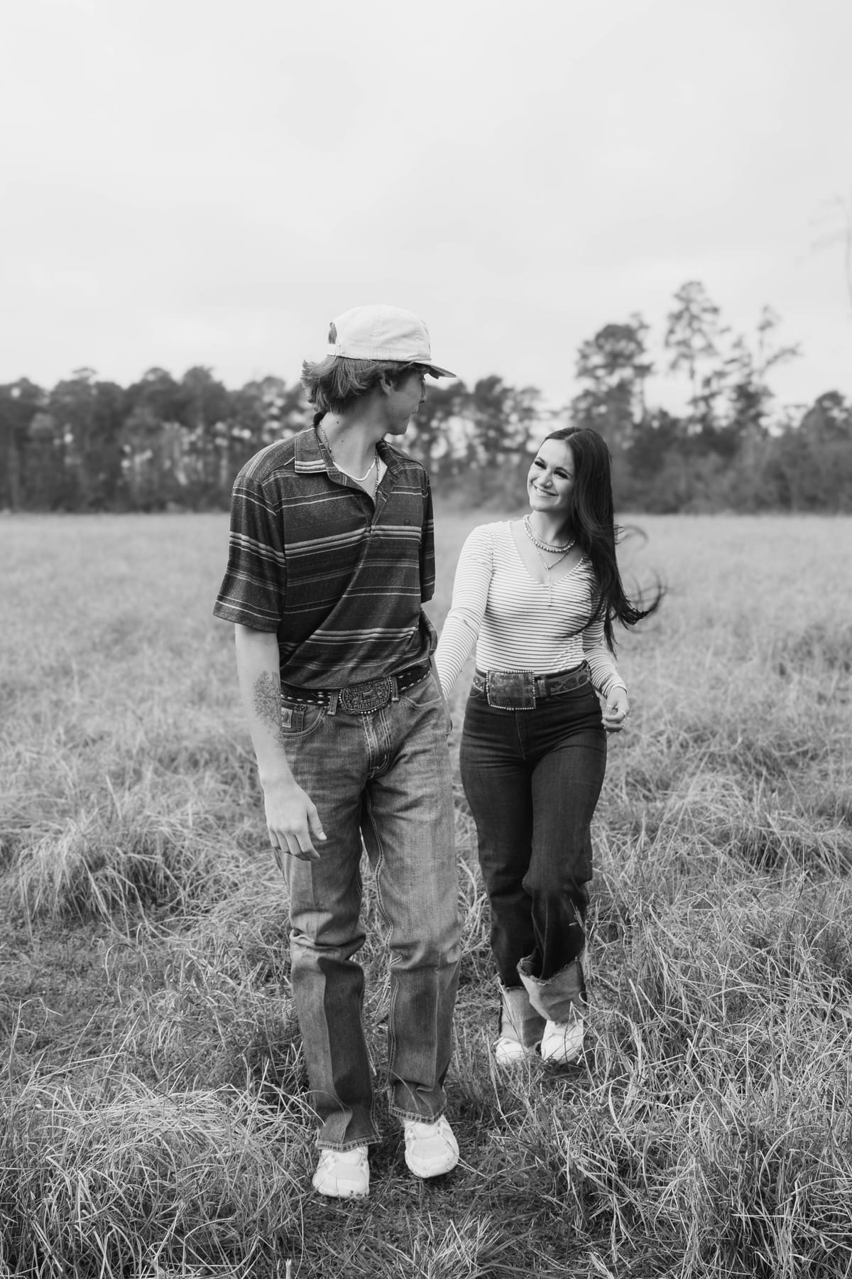 Black and white candid of a couple walking hand in hand